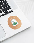 Laptop displaying a Nuts & Lemons Co. diecut sticker featuring  a cute ghostie barista making a latte with the phrase “boorista”