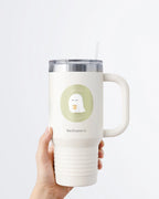 Hand holding a tumbler displaying Nuts & Lemons Co. diecut sticker featuring  a cute ghostie holding hot green tea with the phrase “boo tea”