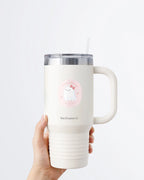 Hand holding a tumbler displaying Nuts & Lemons Co. diecut sticker featuring a cute ghostie with a pink bow surrounded by heart cherries with the phrase “lookin’ faboolous”
