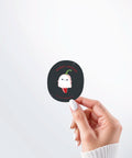 Hand holding a Nuts & Lemons Co. diecut sticker featuring a cute ghost pepper dressed as a ghostie  with the phrase “ghost pepper”