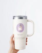 Hand holding a tumbler displaying Nuts & Lemons Co. diecut sticker featuring a cute ghostie wearing a starry wizard hat, a magic wand  and a sign with the phrase “hocus focus”