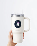 Hand holding a tumbler displaying Nuts & Lemons Co. diecut sticker featuring a cute ghostie in a witch hat with a bubbling cauldron with the phrase “if you got it, haunt it”
