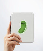 A hand holding a white kindle cover with a Nuts & Lemons Co. diecut sticker on it featuring a dill pickle with shades with the phrase “Kind of a Big Dill”