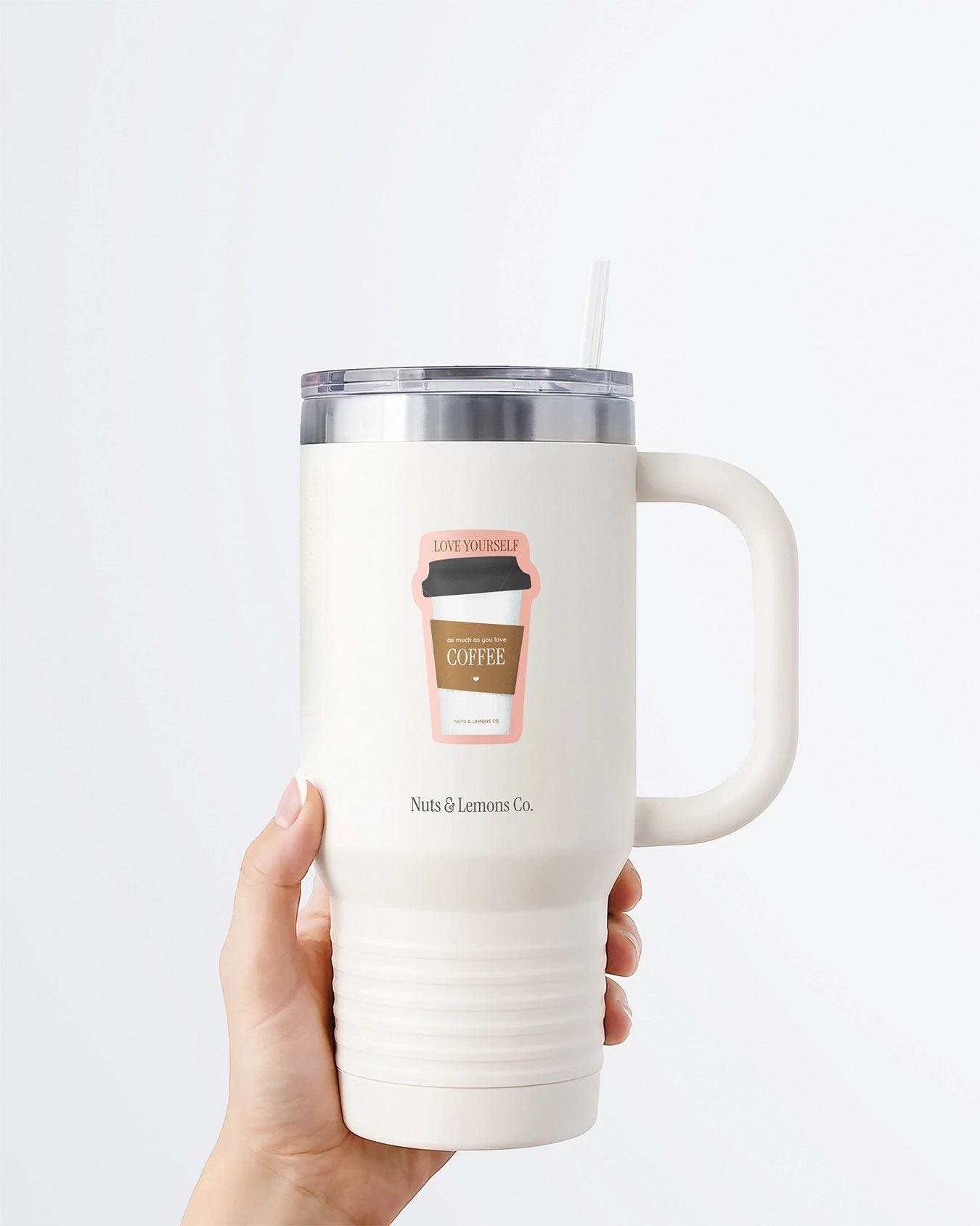 Hand holding a tumbler displaying a Nuts & Lemons Co. diecut sticker featuring a togo coffee with the phrase “love yourself like you love your coffee”