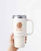 Hand holding a tumbler displaying Nuts & Lemons Co. diecut sticker featuring a walnut drooling asleep with the phrase “nut today too tired”