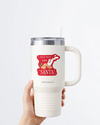 Hand holding a tumbler displaying Nuts & Lemons Co. diecut sticker featuring a bunch of cookies and spilling milk with the phrase “I put out for Santa”