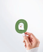 Hand holding a Nuts & Lemons Co. diecut sticker featuring a cute ghostie eating spaghetti with the phrase “spook-etti”

