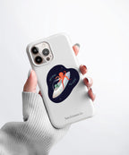 A hand holding a white phone case with a Nuts & Lemons Co. diecut sticker on it featuring a sleeping polar bear with the phrase “Rest is Productive”