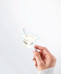 Hand holding a Nuts & Lemons Co. diecut sticker featuring a yogurt cup with the phrase “Yogurt Has More Culture”