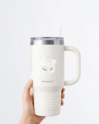 A hand holding a white tumbler with a Nuts & Lemons Co. diecut sticker on it featuring a yogurt cup with the phrase “Yogurt Has More Culture”